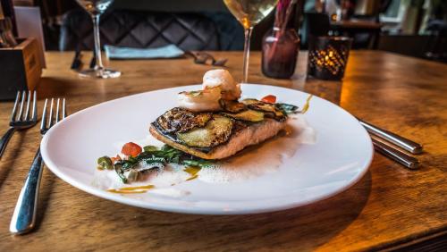 a white plate with food on a table at Hotel Café Restaurant 't Raedhûs in Dokkum