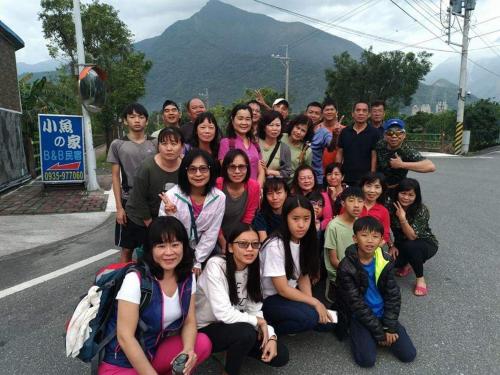 a group of people posing for a picture on a street at Taroko Little Fish in Xincheng