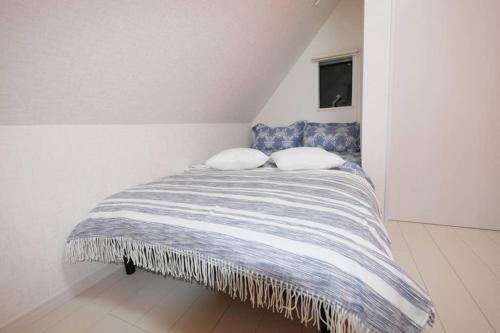 Ένα ή περισσότερα κρεβάτια σε δωμάτιο στο アンドステイ高砂2丁目