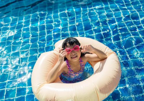 a woman in an inner tube in a swimming pool at Nostalgia Boutique Hotel in Da Nang