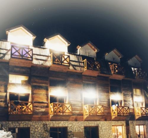 a building with balconies on the side of it at night at Apartman Dunja -Ski skola in Kopaonik