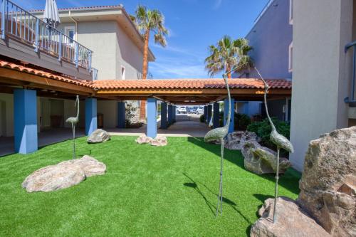 
a grassy area with a lawn chair and patio area at Best Western Premier Santa Maria in LʼÎle-Rousse
