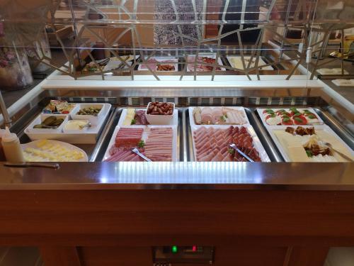 a refrigerator filled with lots of different types of food at Hotel Köln-Bonn in Bornheim