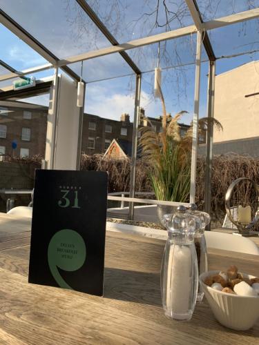 a sign sitting on a table with a bowl of food at Number 31 in Dublin