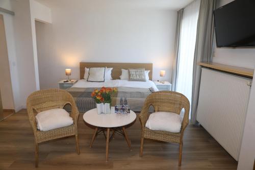Posteľ alebo postele v izbe v ubytovaní Hotel Weinlaube