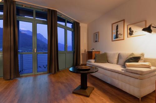 a living room with a couch and a table at Hotel Esplanade in Gmunden
