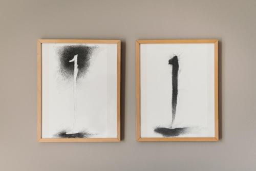 two framed pictures of numbers on a wall at Hotel Esplanade in Gmunden