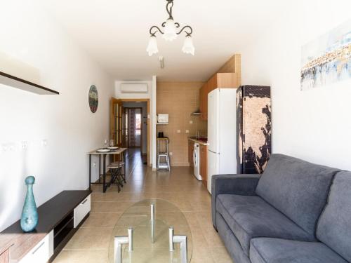 uma sala de estar com um sofá e uma mesa de vidro em Belvilla by OYO Apartment in Roquetas de Mar em Aguadulce