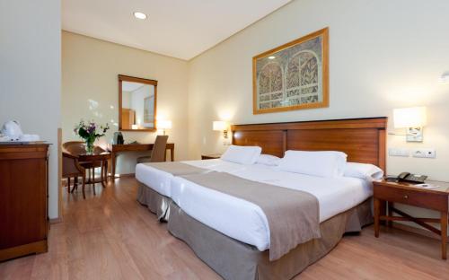 Cama o camas de una habitación en Hotel Bécquer