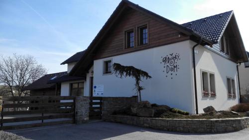 a house with graffiti on the side of it at Penzión Uhliská a Depandance Gazdovský dom in Nemšová