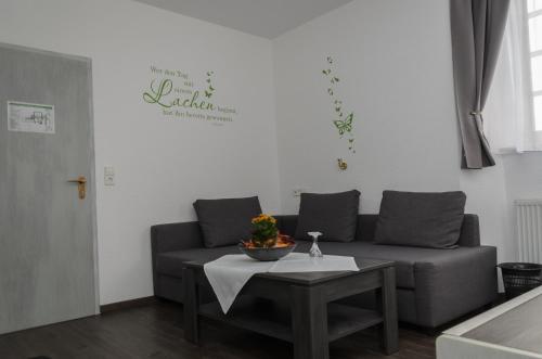 a living room with a couch and a table at Hotel Rheingraf in Kamp-Bornhofen
