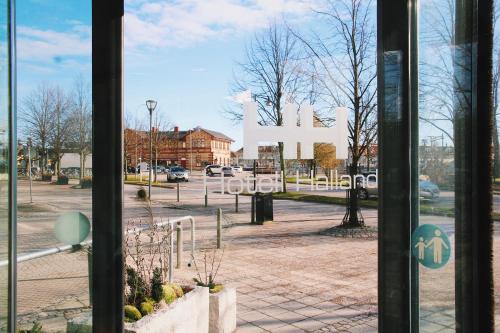 a window view of a parking lot with a large sign at Best Western Hotel Halland in Kungsbacka