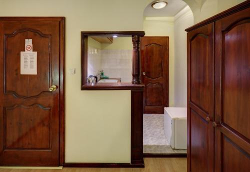 a bathroom with a sink and a mirror next to a door at Guest House Rakovina in Sozopol