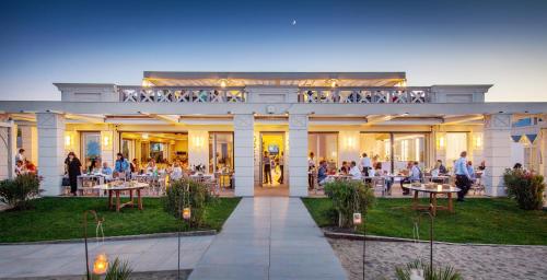 a group of people sitting at tables on a building at Grand Hotel Da Vinci in Cesenatico