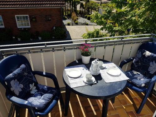 a table and chairs sitting on a balcony at Ferienhaus Poseidon in Neuharlingersiel