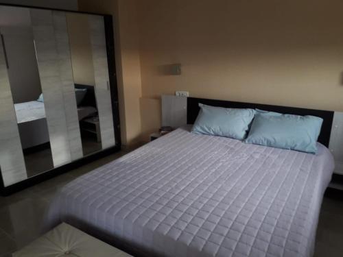 a bedroom with a bed with a large mirror at InStyle Zakynthos town Apartment in Zakynthos