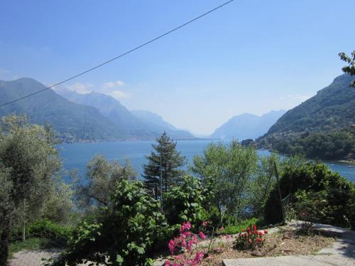 a view of a lake with mountains in the background at casa indipendente "IL SOLE DELLE GRIGNE" in Bellagio