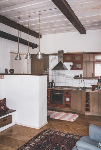 a large kitchen with wooden cabinets and stainless steel appliances at Gemütliches Wohnen in der alten Schule in Weitra