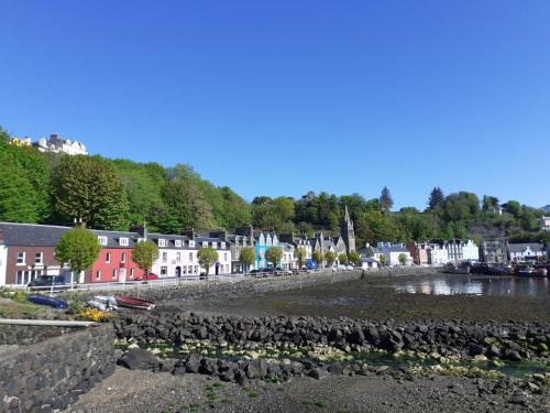 a view of a town with a river and houses at Glenelg in Tobermory
