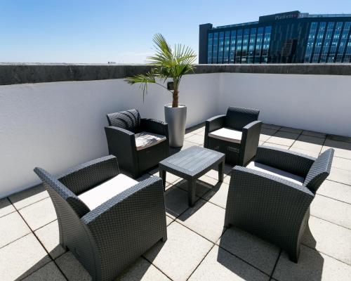 a group of chairs and tables on a patio at The Queens Hotel in Leeds