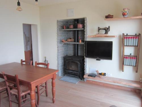 a living room with a table and a fireplace at casa indipendente "IL SOLE DELLE GRIGNE" in Bellagio