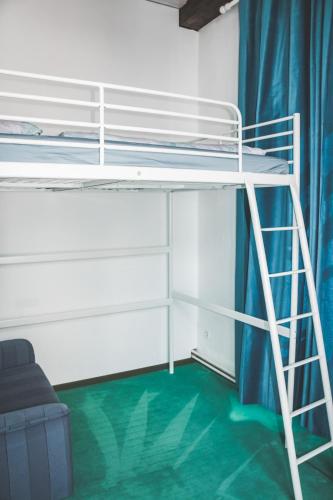 a bunk bed with a ladder in a room at Gemütliches Wohnen in der alten Schule in Weitra
