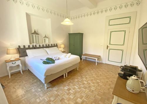 a bedroom with a white bed and a green door at Residenza del Duse in Bologna