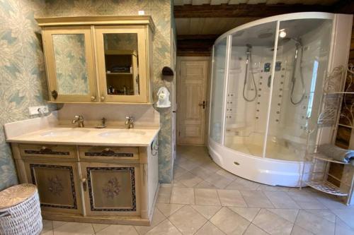 a bathroom with a shower and a sink and a tub at Beach House Ežurgas in Tūja