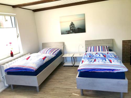 Un pat sau paturi într-o cameră la Ferienhaus Till & Lotte
