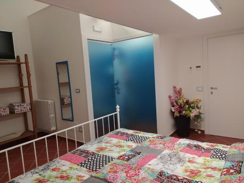a bedroom with a blue door and a bed at B&B La Casa Di Giò in Lanciano