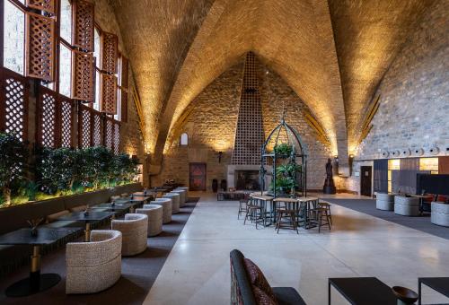 a large room with tables and chairs in a building at Parador de Jaén in Jaén
