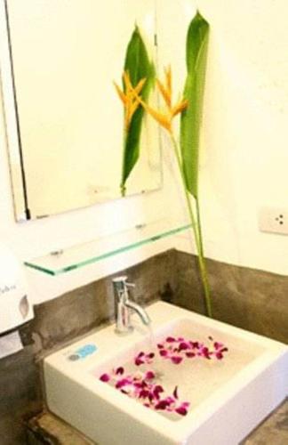 a bathroom with a sink with a flower on it at Krabi Cozy Place in Krabi