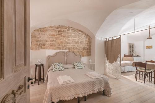 Postel nebo postele na pokoji v ubytování CARMÀ- Antica Tradizione