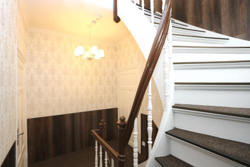 a staircase in a house with white and black stairs at Villa Ostseenordstern in Warnemünde