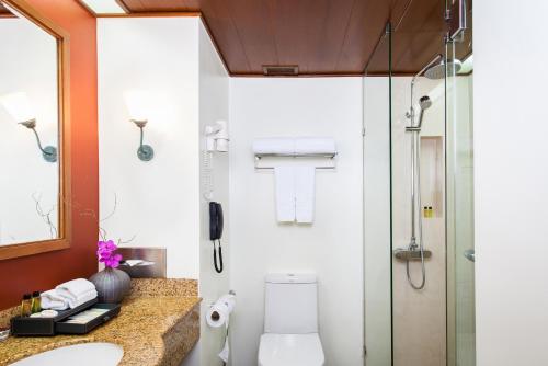a bathroom with a shower and a toilet and a sink at Amari Don Muang Airport Bangkok in Bangkok