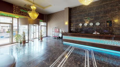 a restaurant with a swimming pool in a lobby at Green Prusa Hotel in Bursa