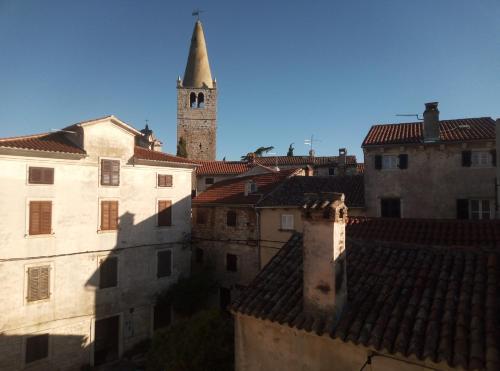 a view of a city with a clock tower and roofs at Apartment Ane in Bale