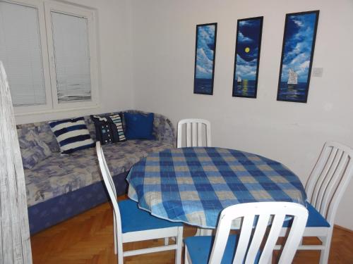 a room with a table and chairs and a couch at Apartmani Anka in Gradac