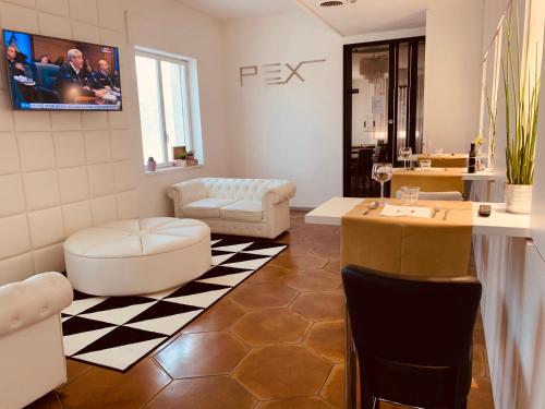 a living room with a couch and a table at Hotel Pex Padova in Rubano