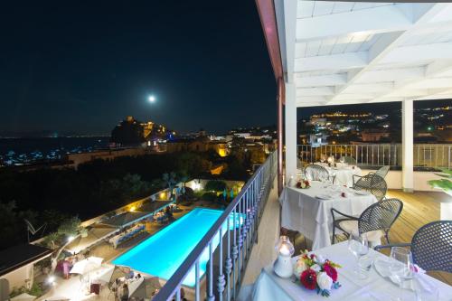 a balcony overlooking a city at night at Hotel Villa Durrueli Resort & Spa in Ischia