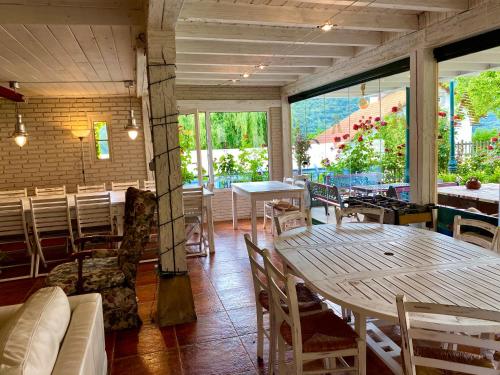 a restaurant with tables and chairs and a large window at Apartamentos Alquitara in Potes