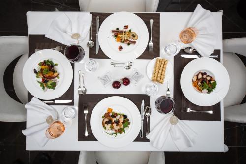 a white table with plates of food on it at Boutique Hotel Vissi d'Arte in Budva
