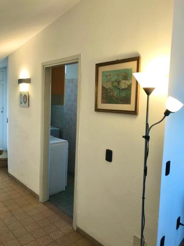a room with a hallway with a lamp and a bathroom at Stella Apartments in Malcesine