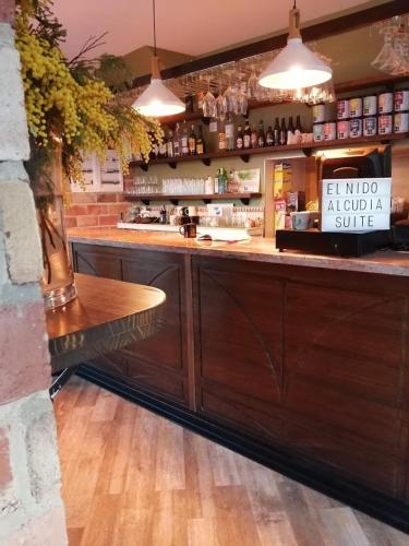 a bar with a counter with a vase on it at Hospedium Hotel El Nido de Alcudia Suites in Almodóvar del Campo