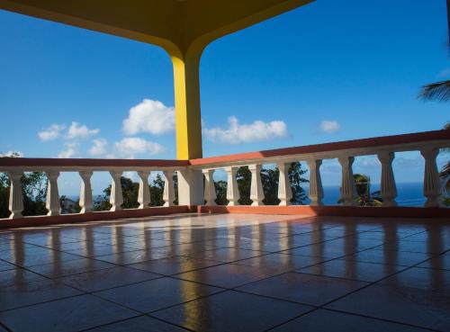 a balcony with a view of the ocean at Paradise Villa Rooms in Plymouth