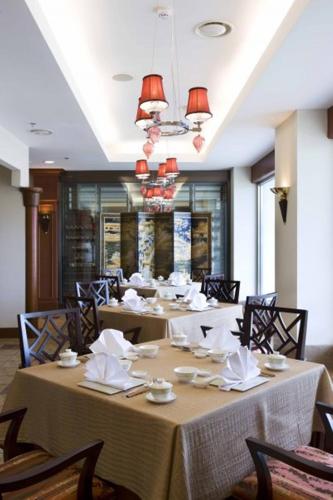 a dining room with a long table with chairs at Jpark Island Resort & Waterpark Cebu in Mactan