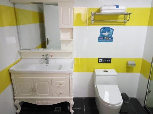 a bathroom with a sink and a toilet at 7Days Inn Yulin Guangji building in Yulin