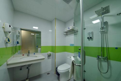 een badkamer met een wastafel, een douche en een toilet bij 7Days Inn Xishuangbanna GaoZhuang West Shuangjing in Jinghong