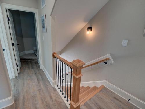 a staircase with a wooden rail and a stair case at Outer Banks Motel - Village Accommodations in Buxton