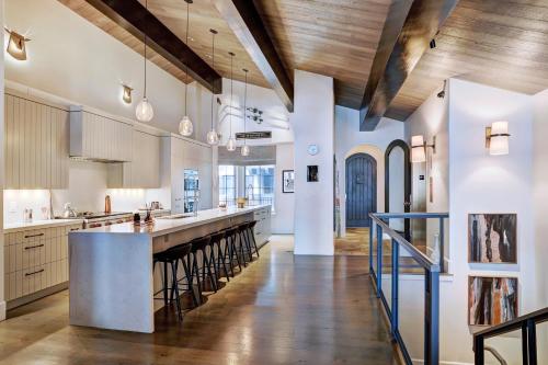 an open kitchen with a long island with stools at Lodge at Vail, A RockResort in Vail